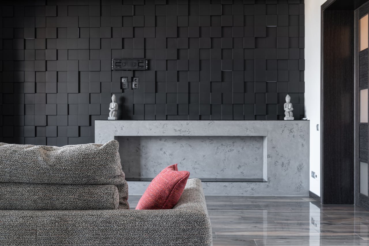 Home Stylish interior design featuring a gray sofa and artistic textured black wall.